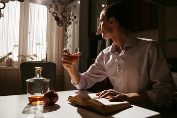 Guy with brandy in the kitchen
