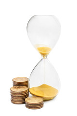 Hourglass with coins on white.