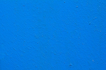 concrete wall is painted with blue paint. Abstract background. Texture for design and project.