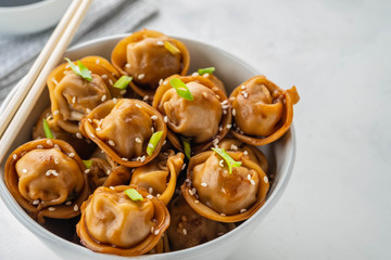 Fried dumplings with soy sauce with pepper and green onions. Asian cuisine. Copy space.