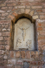 Italy, Venice, a stone building that has a christ on the side of a brick wall