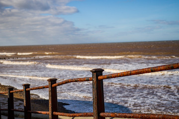 Metal railings on the ramp down to the sandy beach at Cromer on the North Norfolk coast