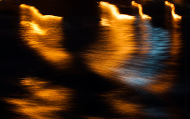 Abstract shapes on water surface at night