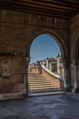 Italy, Venice, a stone building that has a bridge in the background