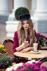 Beautiful young woman in traditional Parisian outdoor cafe
