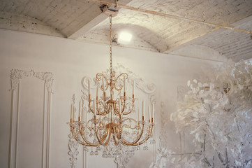 Several crystal chandeliers under the ceiling. Luxury and brilliance