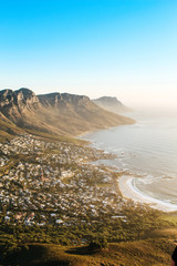 View of the 12 apostles and Camps Bay seen from the peak of Lions Head lookout point at sunset. - obrazy, fototapety, plakaty