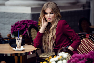 Beautiful young woman in traditional Parisian outdoor cafe
