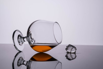 Glass of cognac on on white background. Copy space.