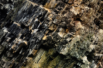 Stone texture, background. Ansient multi-layered surface of rocks