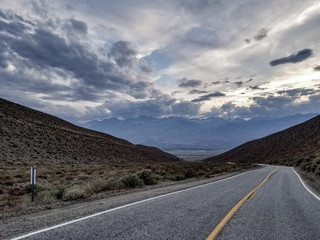 A road headed into the mountains with a curve or vanishing point in the distance