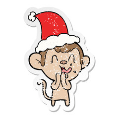 crazy distressed sticker cartoon of a monkey wearing santa hat