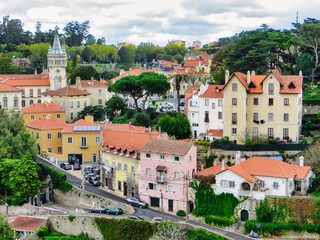 Fototapeta na wymiar Sintra town center with a church, colorful buildings and many trees.