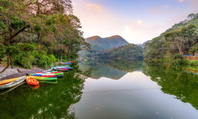 Sattal lake at sunset with scenic landscape and view of tourist boats at Nainital Uttarakhand India.