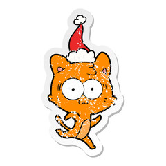 distressed sticker cartoon of a surprised cat running wearing santa hat