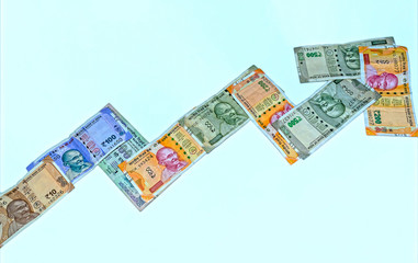 Symbol of stock market, concept, made with new 10,100, 200,and 500 Indian currency on white isolated background.