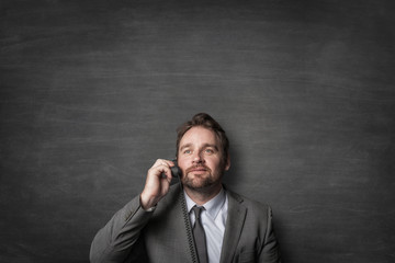 Businessman answering on cord phone