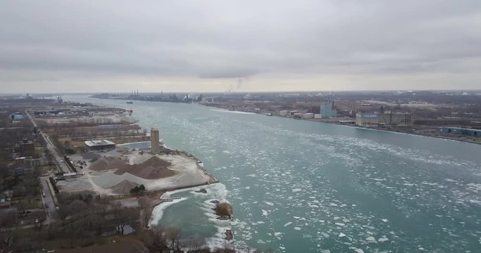 Ice floating down the cold blue water in the Detroit River in Winter.