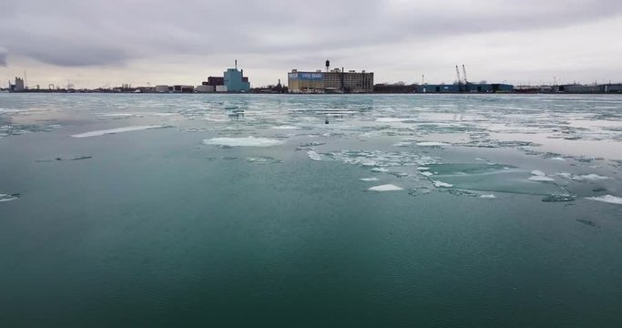 Ice floating in the cold blue water along the Detroit River with Boblo Island in the background.