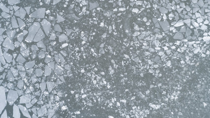 Aerial view over the surface of sea and cracked ice. Climate Change and Global Warming