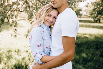 Fototapeta premium Portrait of happy young couple looking at each other and smiling outdoor