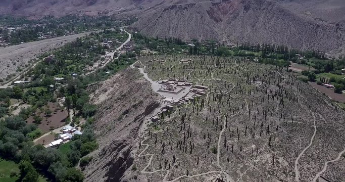 High and wide aerial shot of &ldquo;Pucara de Tilcara&rdquo; and mountains on a sunny day, people visiting the archaeological site.