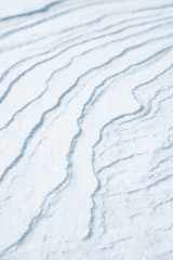 Fresh snow background texture. Winter background with snowflakes and snow mounds. Snow lumps.