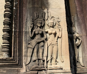 Smiling Apsara dancers stone carving on the wall of Angkor Wat temple, Siem Reap, Cambodia
