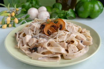 Pasta fettuccine alfredo dish with chicken breast and mushrooms