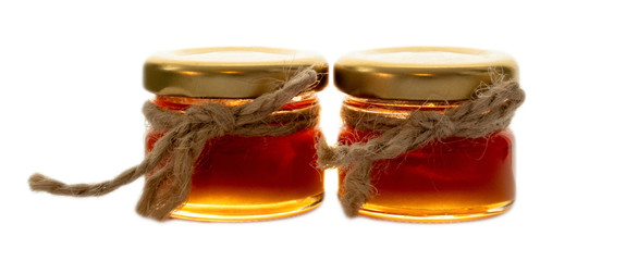 Two small jars with honey decorated with jute string isolated on white background, ideal for wedding gift