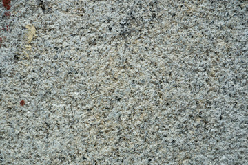 Weathered, old granite wall with rough texture background