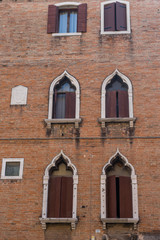 Italy, Venice, ancient windows on a red building