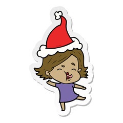sticker cartoon of a girl pulling face wearing santa hat