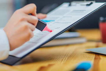 Close up of woman's hand holding marker, drawing, working project, planning strategy, using sticky notes and scrum. University student studying, learning language, examination. Education concept.