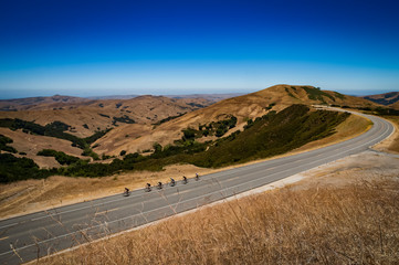 cyclists ride on the road in the central coast of California