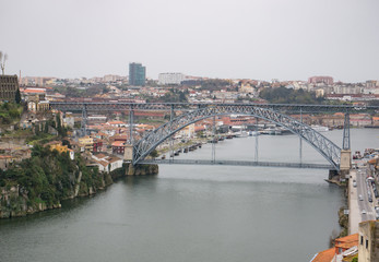 Fototapeta na wymiar Aerial view over River Douro in Porto, Portugal. Rainy, overcast day.