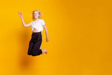 Obraz premium Studio shot portrait young happy laughing playful attractive fashion model woman posing in white dress isolated on orange wall background with copy space. Positive emotion, face expression