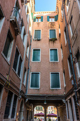 Fototapeta na wymiar Italy, Venice, a view of a city street in front of a brick building