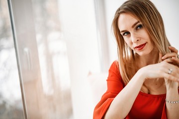 Beautiful girl in a red dress posing at the big .