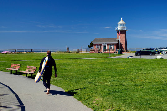 Surfing at Lighthouse Point (aka Santa Cruz Point). Santa Cruz, California, USA.The Point features a surfing museum in a lighthouse & is the location of Steamer Lane, the county's most famous surfing 
