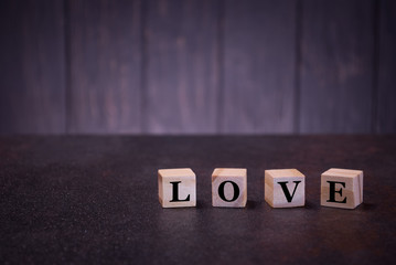 Word love on wooden cubes, light wooden cubes signs