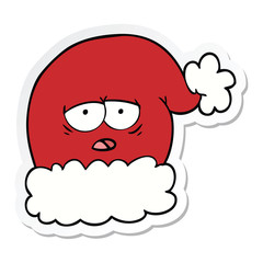 sticker of a cartoon christmas santa hat with tired face