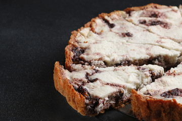 pie with ricotta and cheese close up on dark background