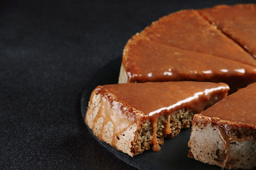 pie with caramel close up on dark background. cake with banana and caramel