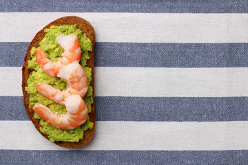 shrimp and avocado on bread with light background healthy breakfast