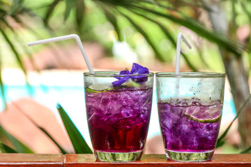 Butterfly pea juice with lemon in cold glass, Thai herb drink for health