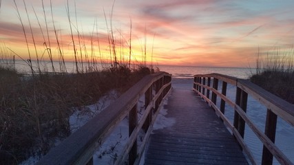 Florida walkway to beach with fiery sunset