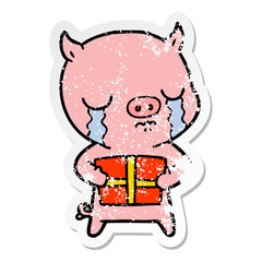 distressed sticker of a cartoon pig crying over christmas present
