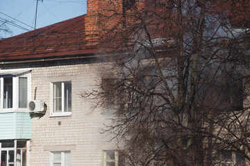 Fototapeta na wymiar Smoke from the window of a burning apartment