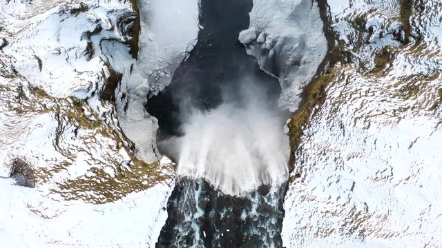 4K Aerial footage of a beautiful waterfall in the snowy mountains
